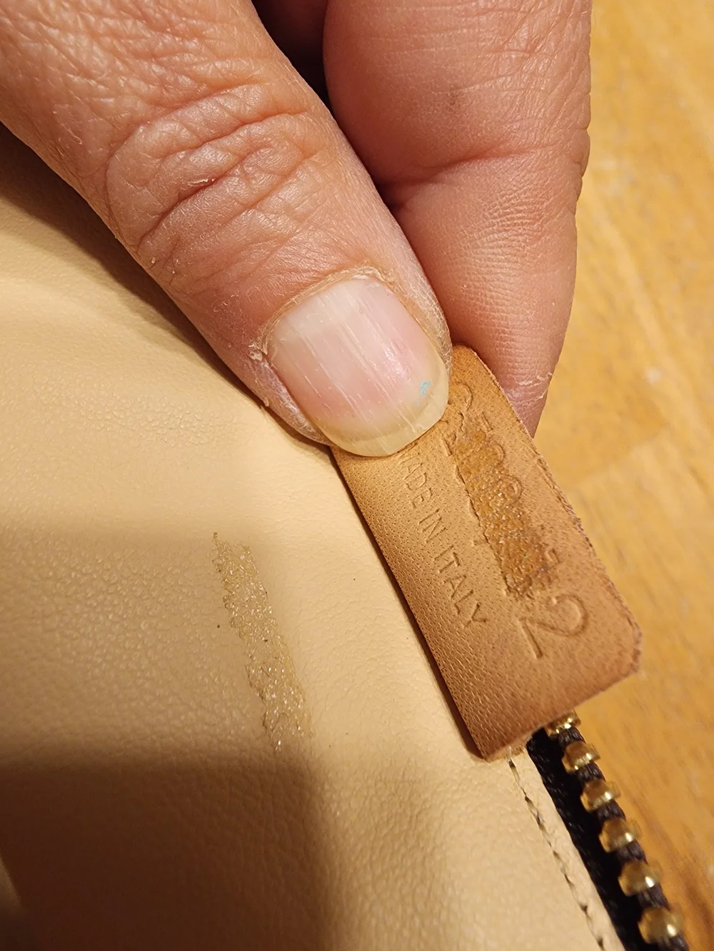 CELINE pouch is crafted from brown Triomphe canvas and features tan leather trim
